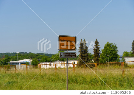 A warm day in Waltershausen with green fields and a welcoming sign indicating the Landkreis Gotha district 118095266
