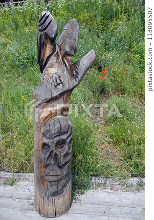 Kiev, Ukraine June 19, 2021: Figures of people and animals carved from wood - entertainment complex Kievan Rus 118095507