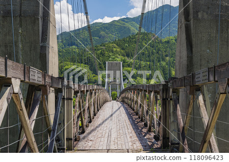 Momosuke Bridge, also known as Momo no Hashi, over the Kiso River in Minami Kiso Town, Kiso District, Nagano Prefecture, Japan Momosuke Bridge, also known as Momo no Hashi, over the Kiso River in Minami Kiso Town, Kiso District, Nagano Prefecture, Japan 118096423