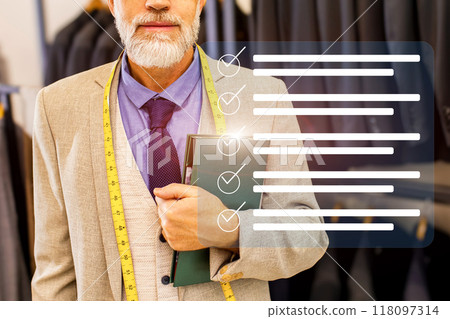 A man is holding a book and a tape measure A man is holding a book and a tape measure 118097314
