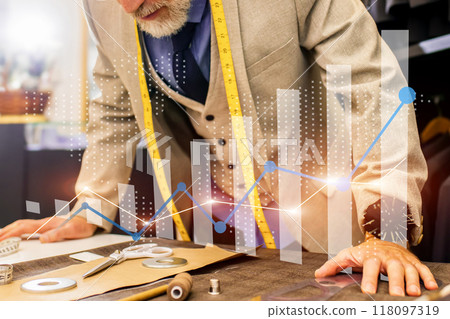 A man is working on a project with a graph on the table A man is working on a project with a graph on the table 118097319
