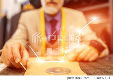 A man is sitting at a desk with a graph on a piece of paper A man is sitting at a desk with a graph on a piece of paper 118097321