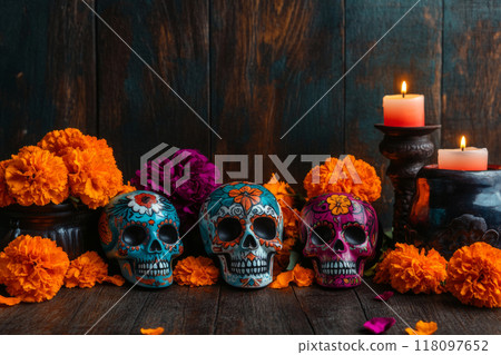 Decorated sugar skulls, marigold flowers, and lit candles 118097652