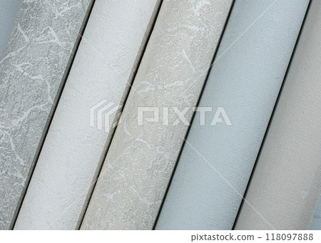 Multi-colored tubes of paper wallpaper for repairs rolled into rolls. Multi-colored tubes of paper wallpaper for repairs rolled into rolls. 118097888