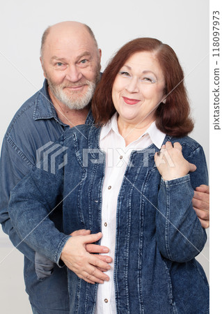 Portrait of an elderly cheerful couple in love in denim clothes. 118097973