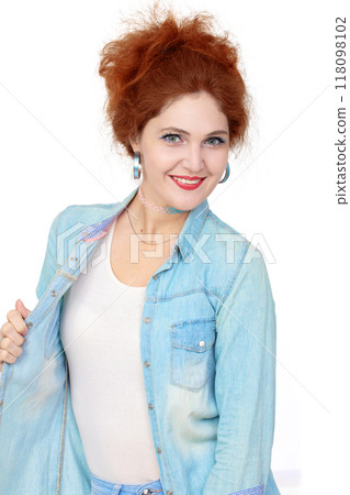 Portrait of a beautiful cheerful redhead girl in a denim shirt, smiling and laughing, looking at the camera on a white background. Portrait of a beautiful cheerful redhead girl in a denim shirt, smiling and laughing, looking at the camera on a white background. 118098102