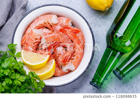 Fresh raw shrimps, accompanied by sprigs of fresh parsley and juicy lemon 118098635
