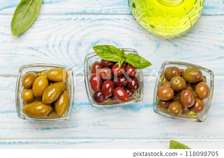 An assortment of various olives presented in a bowl, showcasing different colors, textures, and flavors An assortment of various olives presented in a bowl, showcasing different colors, textures, and flavors 118098705