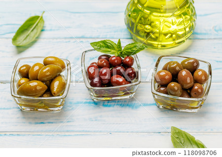 An assortment of various olives presented in a bowl, showcasing different colors, textures, and flavors 118098706