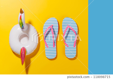 A vibrant summer vacation scene with flip flops and a floating flamingo A vibrant summer vacation scene with flip flops and a floating flamingo 118098715