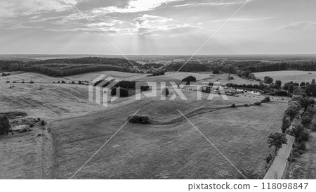A breathtaking view of a mountain landscape at sunset, with a clear blue sky, soft clouds, and a scenic village below. Perfect for travel, nature, and outdoor-related projects. A breathtaking view of a mountain landscape at sunset, with a clear blue sky, soft clouds, and a scenic village below. Perfect for travel, nature, and outdoor-related projects. 118098847