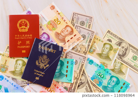 It symbolizes confrontation between economies of China, United States when authentic passports are presented with Chinese currency, yuan, US dollars banknotes various denominations. It symbolizes confrontation between economies of China, United States when authentic passports are presented with Chinese currency, yuan, US dollars banknotes various denominations. 118098964