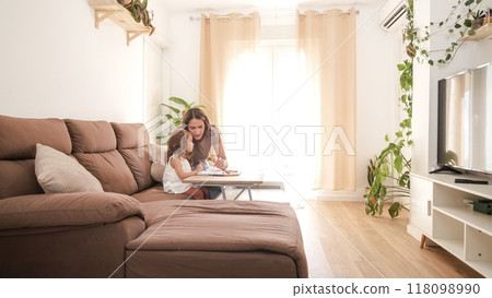 Loving mother and daughter drawing on sofa at home Loving mother and daughter drawing on sofa at home 118098990