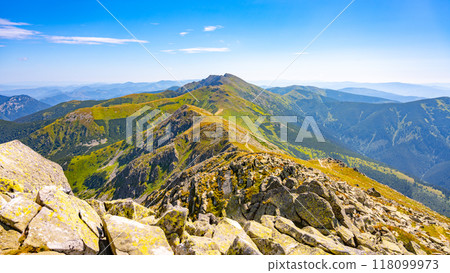Explore the breathtaking panorama from Dumbier Mountain, showcasing the lush valleys and rugged peaks of the Low Tatras in Slovakia on a clear, sunny day. Explore the breathtaking panorama from Dumbier Mountain, showcasing the lush valleys and rugged peaks of the Low Tatras in Slovakia on a clear, sunny day. 118099973