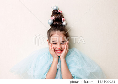 Portrait of funny girl with a hairstyle in the form of a Christmas tree 118100983