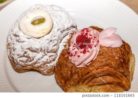 Mardi Gras buns with cream on a white plate. Mardi Gras buns with cream on a white plate. 118101665