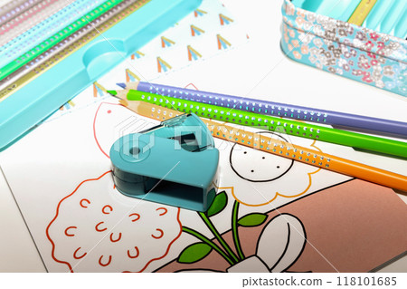Colored pencils for drawing various colors and coloring book for children.  118101685