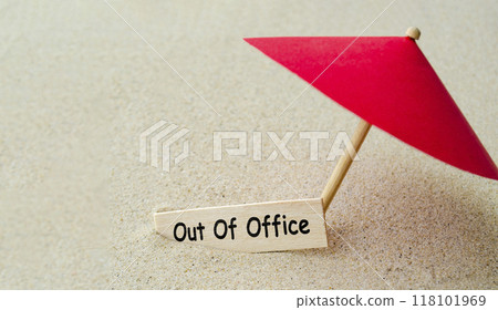 Out of office text on wooden banner with toy umbrella representing off duty. Out of office concept. 118101969