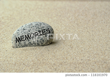 Memories text on stone buried in the sand 118101970