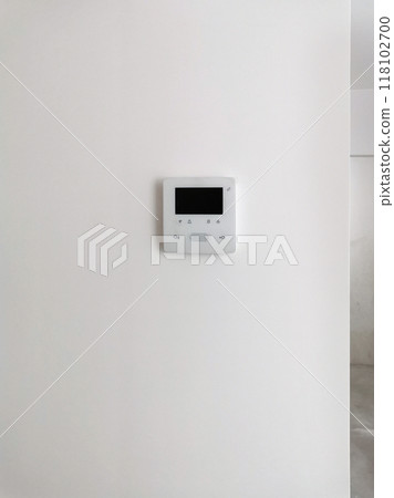Intercom with video, controller on a white background on the wall with plaster in the interior. Modern technologies, smart home, apartment and house design, video communication and broadcasting Intercom with video, controller on a white background on the wall with plaster in the interior. Modern technologies, smart home, apartment and house design, video communication and broadcasting 118102700