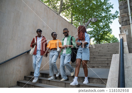 Excited about exam group of african american students go down to underpass on way to college talking Excited about exam group of african american students go down to underpass on way to college talking 118102938