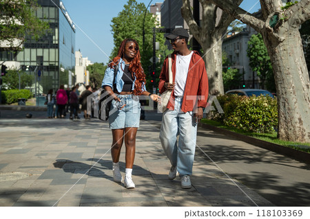 Happy african american couple students walking together on street enjoy chatting gossips fun talking Happy african american couple students walking together on street enjoy chatting gossips fun talking 118103369