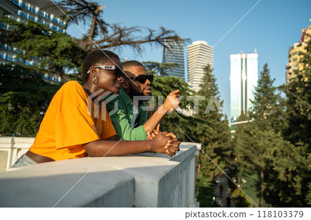 Interested contented african american couple tourists resting in trip enjoy panoramic view of city. 118103379