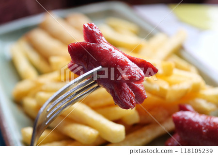 A plate of sausages and fries a delicious meat dish 118105239