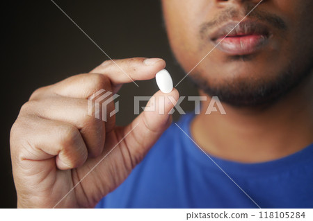 Close up of man hand holding pills with copy space Close up of man hand holding pills with copy space 118105284