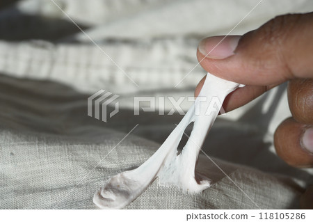 Detailed instructions for effectively removing chewing gum from fabric, with closeup view focus 118105286