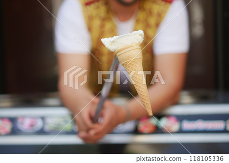 A Delicious Ice Cream Cone is Being Served, Perfect for a Summer Treat or Celebration 118105336