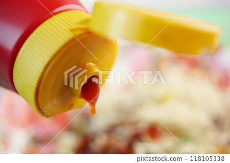 Pouring tasty ketchup from a bottle Pouring tasty ketchup from a bottle 118105338