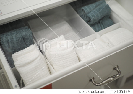 An Organized Bathroom Towel Drawer Featuring Freshly Folded Towels for Easy Access and Neatness 118105339