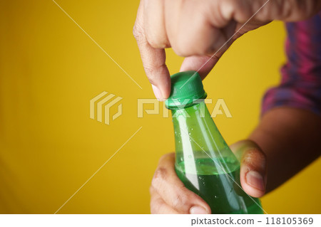 Opening a sealed Green Bottle can be exciting, especially when seeking a refreshing drink Opening a sealed Green Bottle can be exciting, especially when seeking a refreshing drink 118105369