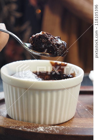 Delicious Chocolate Lava Cake with Powdered Sugar and Whipped Cream on Wooden Plate 118105396