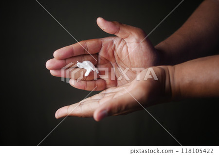 Closeup view of a moisturizing routine showing the application of skincare cream on hands 118105422