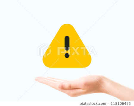 Woman's hand holding a caution sign 118106455