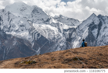 Rear view of tourist sitting on top of Tsergo Ri (4,990m) the high point on the Langtang valley trek of Nepal. 118106775
