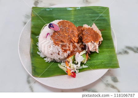 Overhead view on authentic simple Nasi Dagang, popular delicacy in Terengganu served with mackerel fish fillet and gravy. Overhead view on authentic simple Nasi Dagang, popular delicacy in Terengganu served with mackerel fish fillet and gravy. 118106787