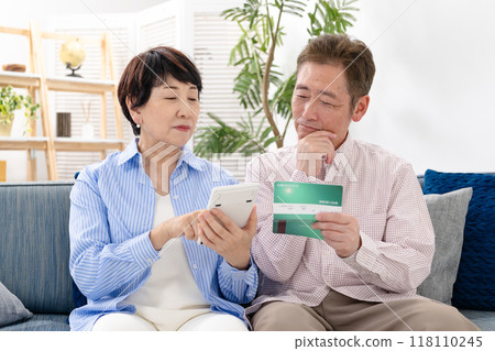 Senior couple troubled watching passbook Senior couple troubled watching passbook 118110245