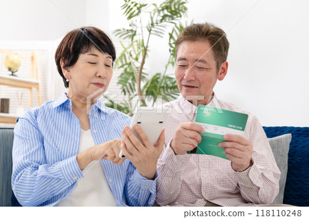 Senior couple troubled watching passbook Senior couple troubled watching passbook 118110248