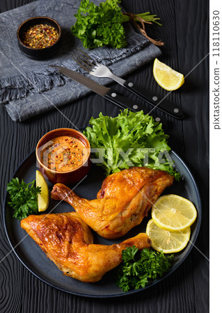 fried chicken legs with lettuce, lemon on plate 118110630