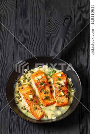 salmon piccata with lemon caper sauce in a pan salmon piccata with lemon caper sauce in a pan 118110633