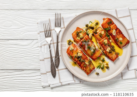 salmon piccata with lemon caper sauce on plate 118110635