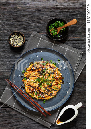 Japanese pancake with cabbage on a plate, top view 118110639