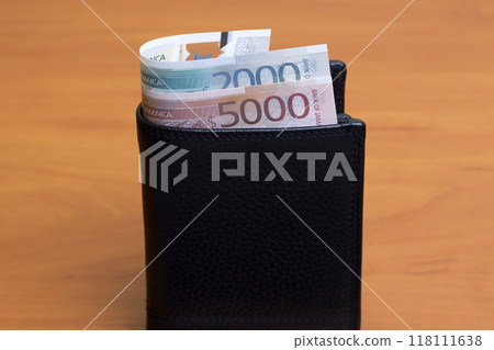 Jamaican dollar in the black wallet 118111638
