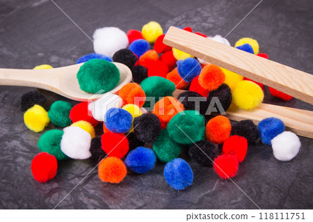Colorful pompoms using for development of kids motor skills, coordination and logical thinking Colorful pompoms using for development of kids motor skills, coordination and logical thinking 118111751