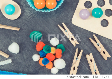 Colorful pompoms, balls and rubber erasers using for development of kids motor skills 118111755