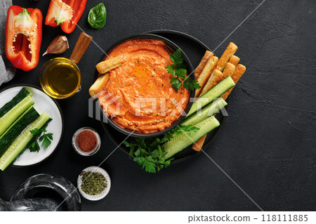 Htipiti - Greek red pepper and feta dip on black bowl on dark background. top view, copy space 118111885