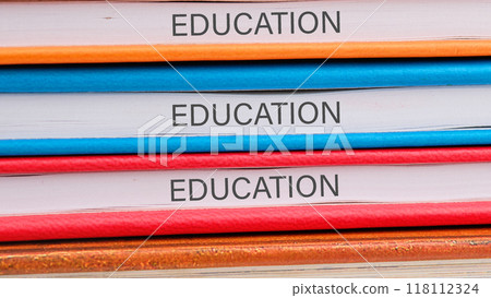 EDUCATION words on the ends of notebooks lying on top of each other 118112324